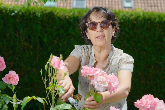 Middle-aged woman with sunglasses in the garden