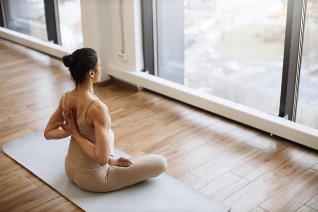 Middle aged women practicing yoga in lotus pose or padmasana