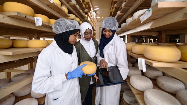 middle eastern black african muslim female business woman team in local  cow and goat milk cheese food production company