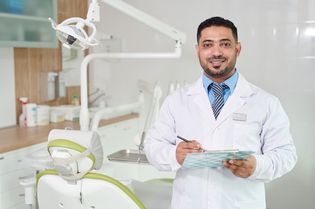 Middle-Eastern Dentist with Clipboard