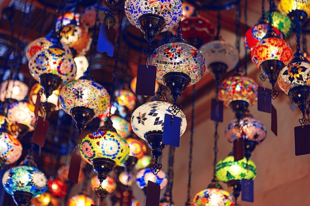 Middle eastern lamps of different colors hanging in bazaar