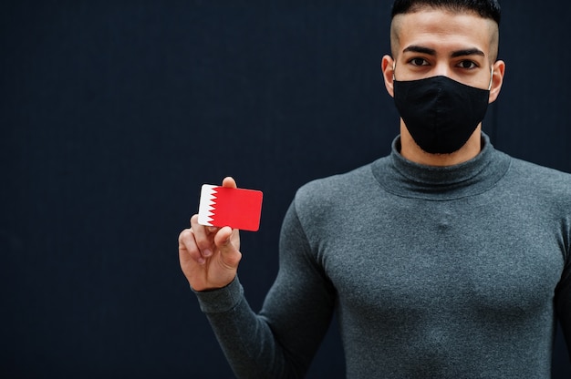 Middle eastern man in gray turtleneck and black face protect mask