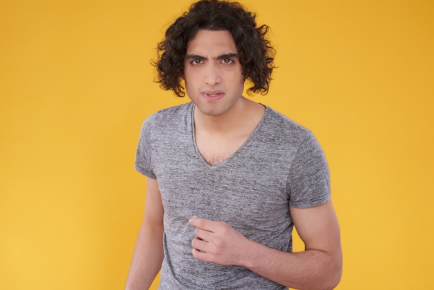 Middle Eastern man posing with a serious face and curly hair