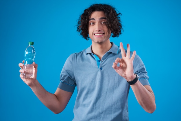 Middle Eastern man posing with water isolated.