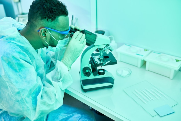 Middle-Eastern Scientist Using Microscope