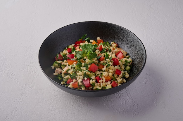 Middle eastern traditional salad tabbouleh made of bulgur or couscous poultry meat parsley mint