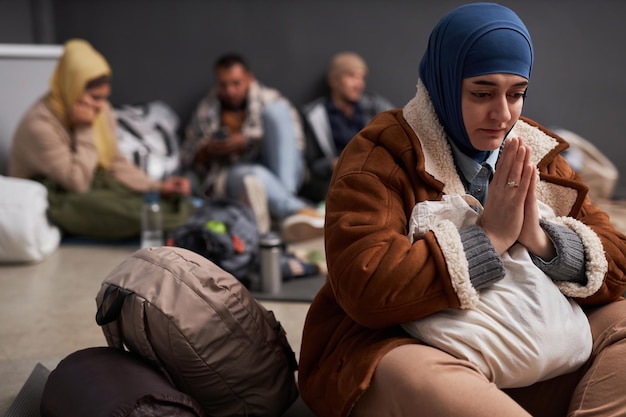 Middle eastern woman wearing hijab and praying