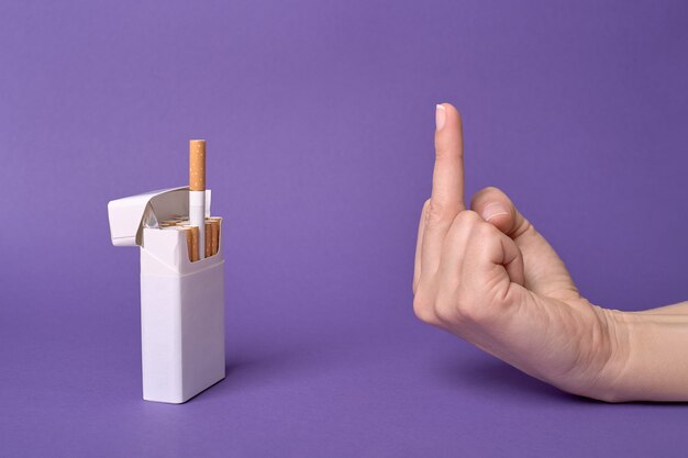 The middle finger, hand gesture to a cigarette treat from a pack, refusing cigarette