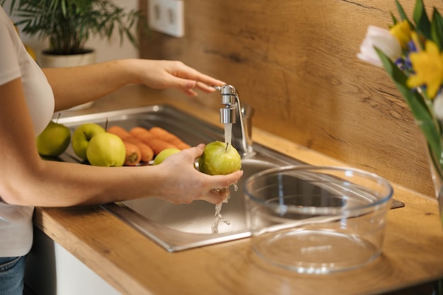 Middle select of woman wash apples preparing fruits for healthy homemade juice