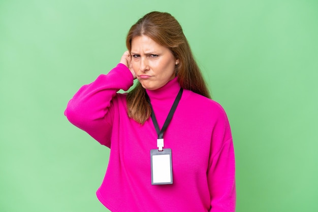 Middleaged caucasian woman with ID card over isolated background having doubts