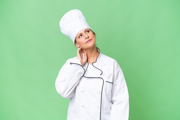 Middleaged chef woman over isolated background thinking an idea
