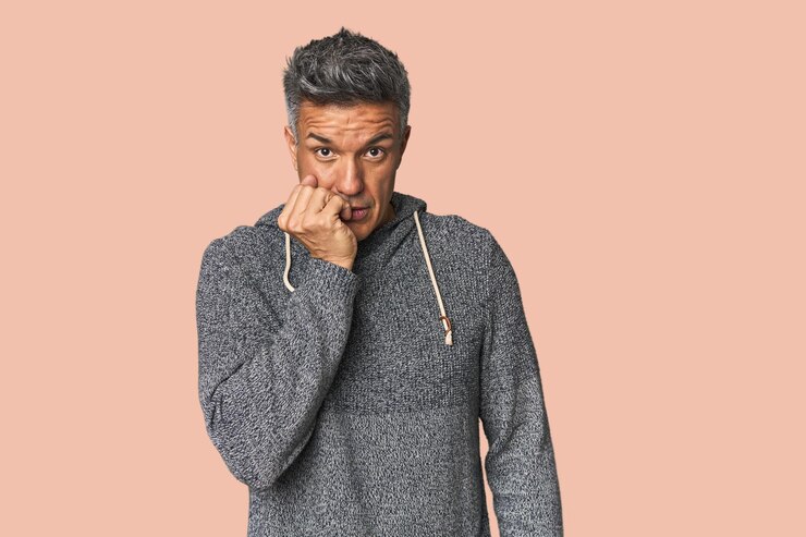 Photo middleaged latino man biting fingernails nervous and very anxious