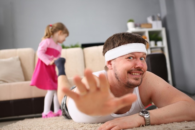 Middleaged man doing sports exercises at home