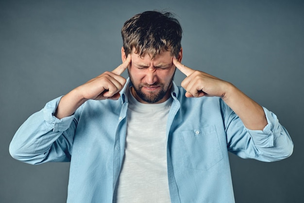 A middleaged man holds his hands on his head The concept of emotional stress crisis and problems