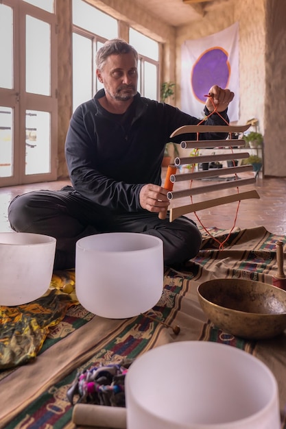 Middleaged man playing a Samafon a vibroacoustic instrument