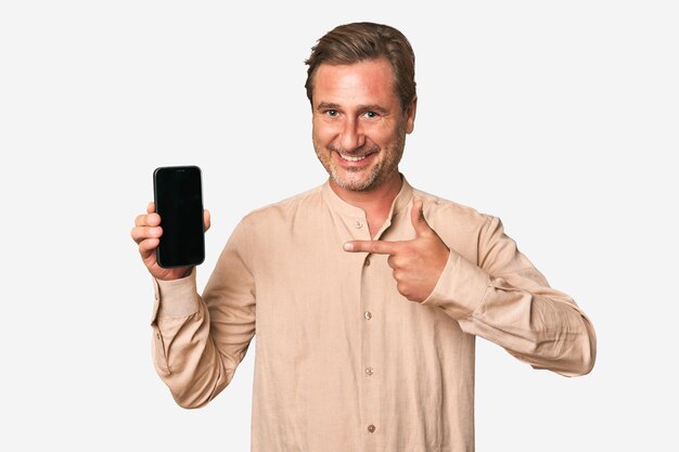 Foto un uomo di mezza età che mostra il display del suo telefono per promuovere qualcosa