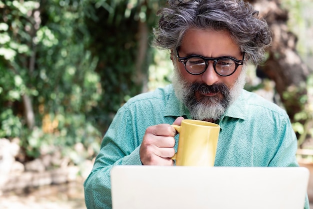 Middleaged man working at home in the garden in nature