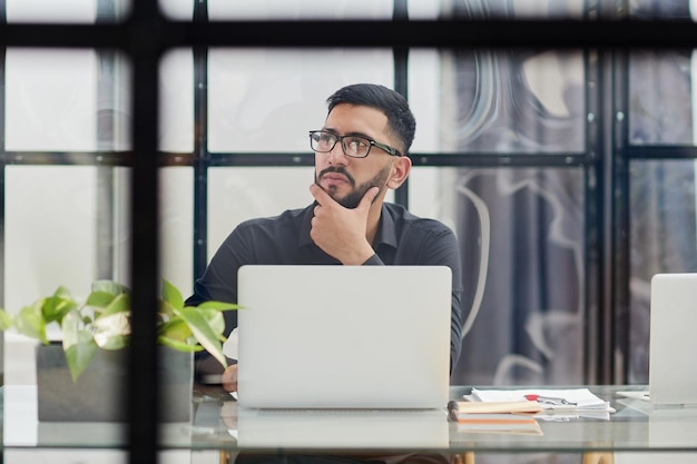 Middleaged man working on laptop in office