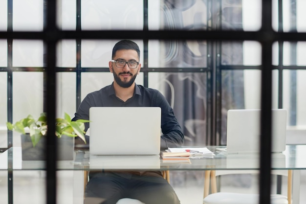 Middleaged man working on laptop in office