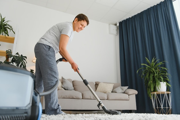 Middleaged woman cleaning new apartment