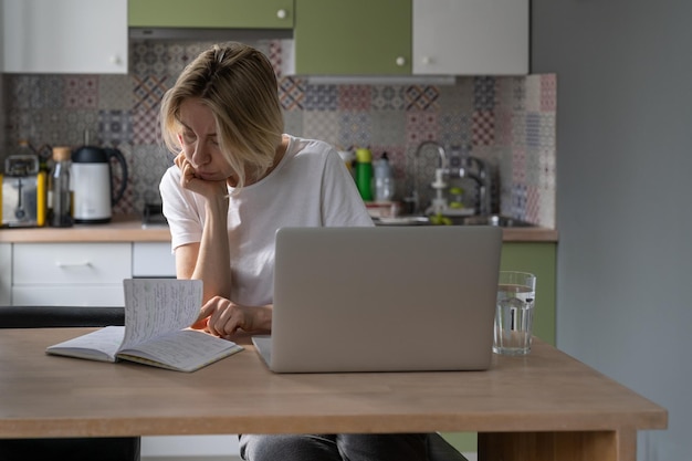 Middleaged woman reads notes about found job vacancies and\
prepares worthy resume closeup