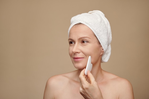 Middleaged Woman Using Gua Sha