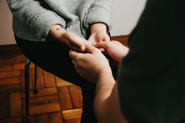 Midsectie van psycholoog die de hand van patiënt vasthoudt