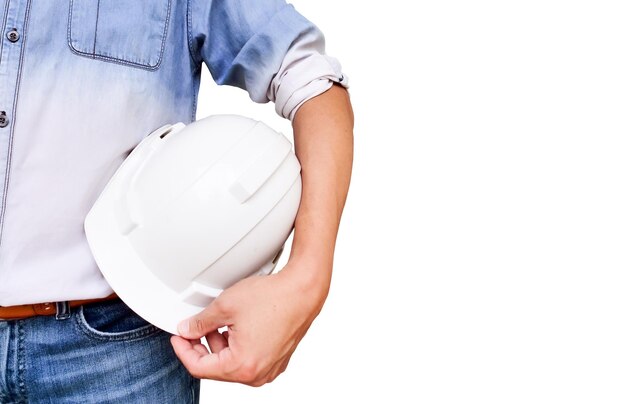 Midsection of architect holding hardhat while standing against white background