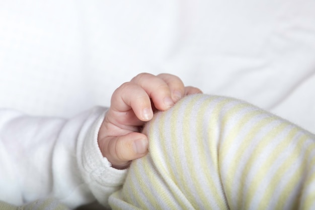 Photo midsection of baby on bed at home