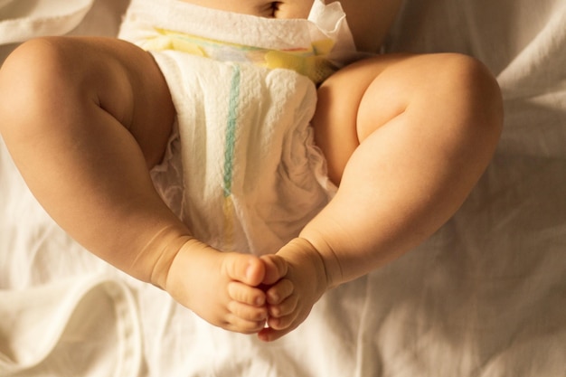 Photo midsection of baby on bed