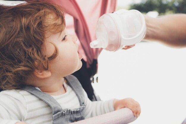 Midsection of boy drinking water