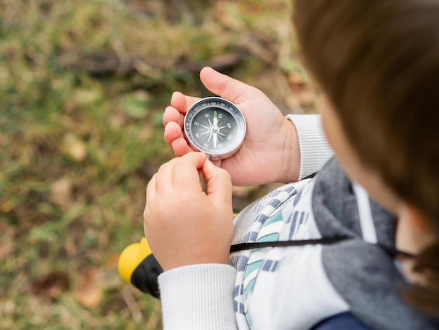 Photo midsection of boy holding compass
