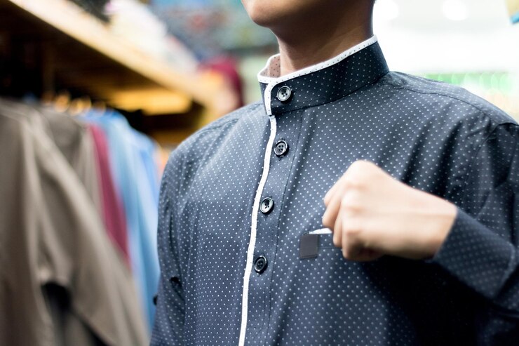 Photo midsection of boy wearing spotted shirt at store