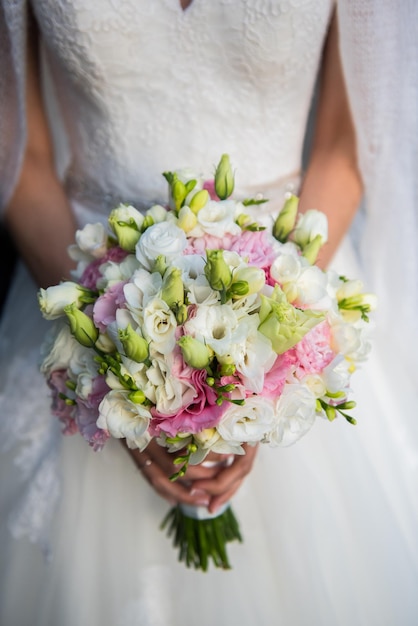 Midsection of bride holding multi colored bouquet