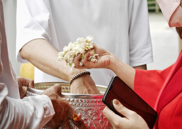 Midsection of bride holding wedding dress