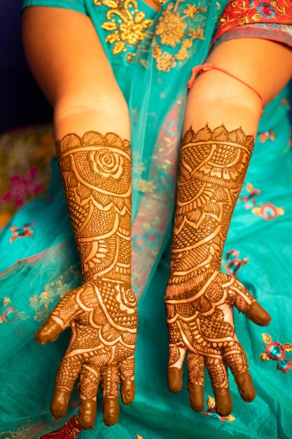 Midsection of bride showing henna tattoo