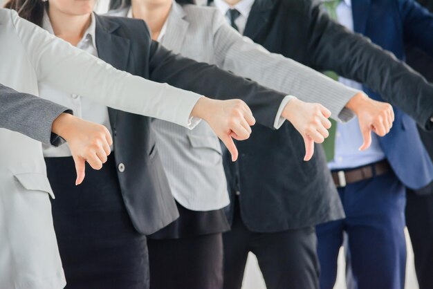 Midsection of business colleagues showing thumbs up