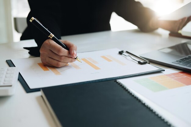 Midsection of business colleagues working on table