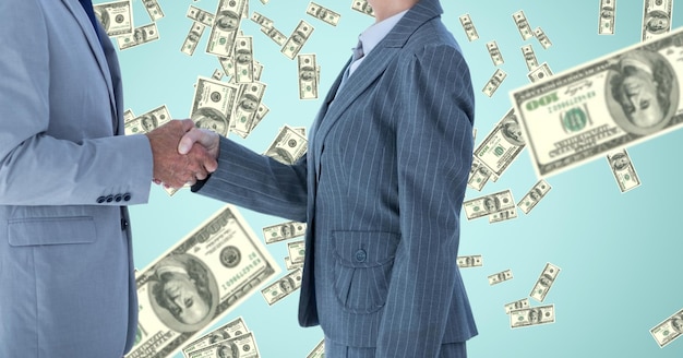 Midsection of business people shaking hands against money