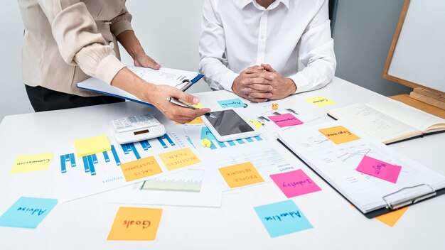 Midsection of business people working on table