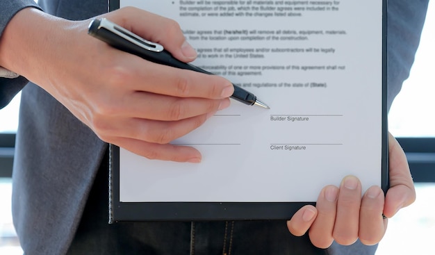 Midsection of business person holding contract paper