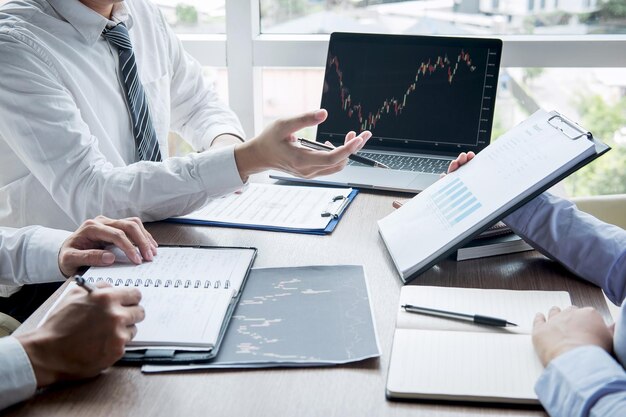 Midsection of businessman discussing data with colleagues in office