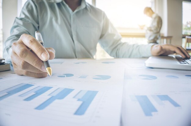 Photo midsection of businessman doing paperwork on desk