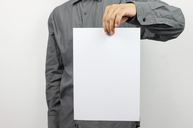 Photo midsection of businessman holding blank paper against white background