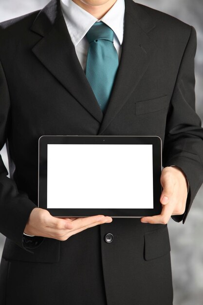 Photo midsection of businessman holding digital tablet