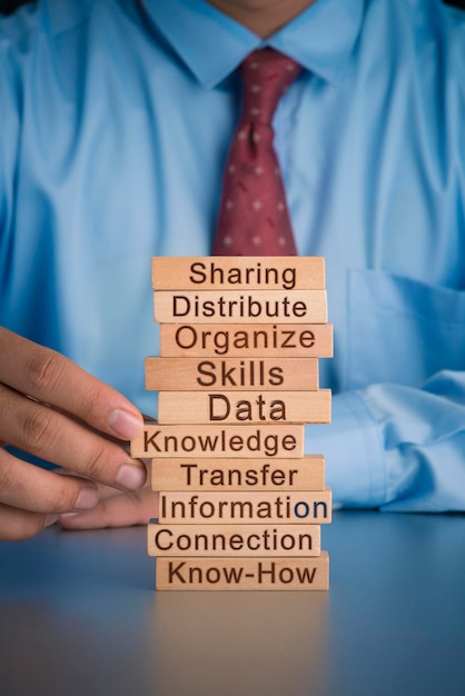 Photo midsection of businessman holding toy blocks with text on table