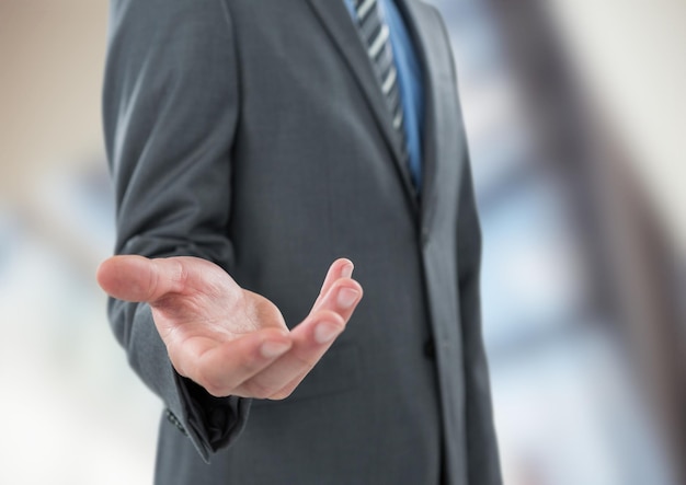 Midsection of businessman offering hand