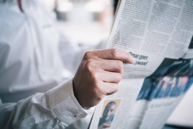 Photo midsection of businessman reading newspaper