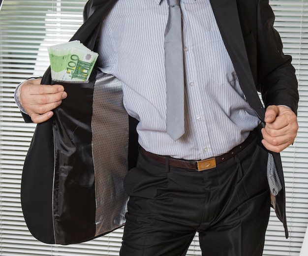 Photo midsection of businessman showing money kept in blazer