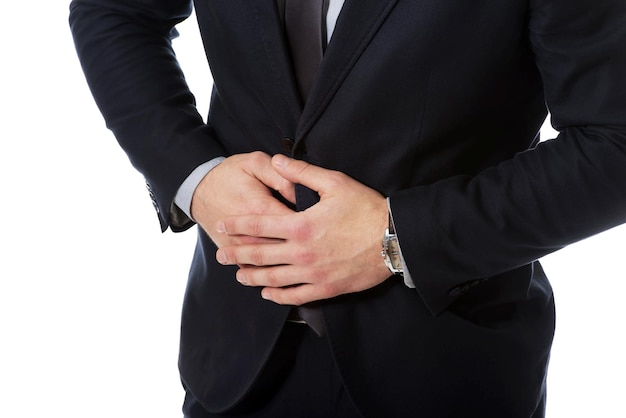 Midsection of businessman standing against white background